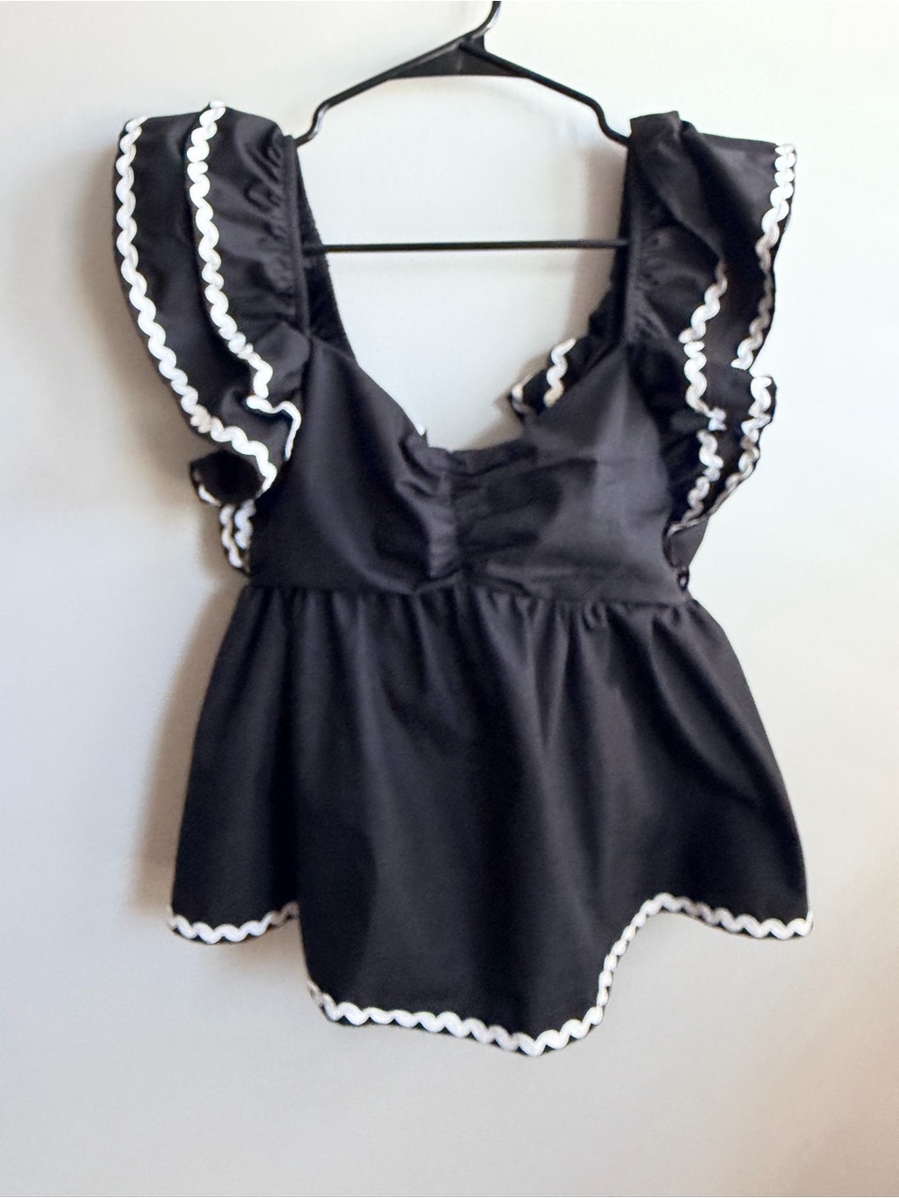 Main Strip Black Ruffled Peplum Top with White Trim